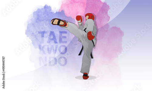 A fighter in the martial arts of taekwondo strikes with his foot. Abstract background.