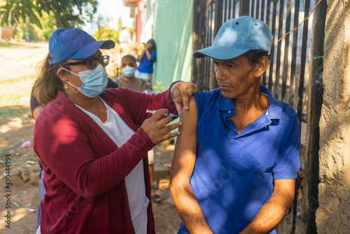 Latino adult man receiving his coronavirus vaccine