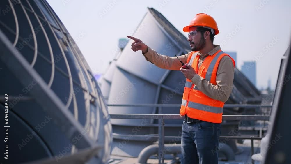 engineer under checking the industry cooling tower air conditioner is water cooling tower air chiller HVAC of large industrial building to control air system. engineer under checking the industry cooling tower air conditioner is water cooling tower air chiller HVAC of large industrial building to control air system.