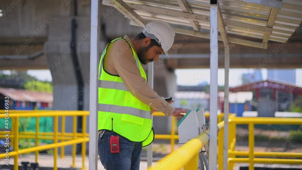 Worker under checking the waste water treatment pond industry large to control water support industry Worker under checking the waste water treatment pond industry large to control water support industry