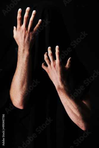 Magic trick. Two arms isolated against a black background.