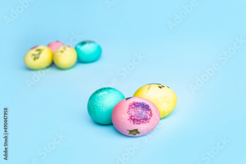 Bright multi-coloured painted Easter eggs on a blue background. Easter