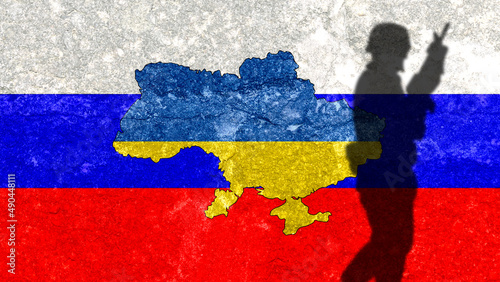  Ukraine map on a wall with Russia flag painted in the background. Shadow of a soldier from Russia's war with Ukraine. War conflict between Russia and Ukraine.