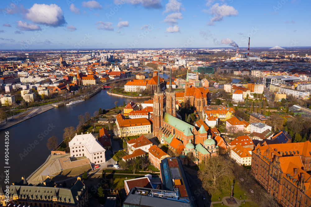 Picturesque aerial view of Wroclaw cityscape on bank of Oder River with medieval Gothic Archcathedral on Ostrow Tumski in spring day, Poland..