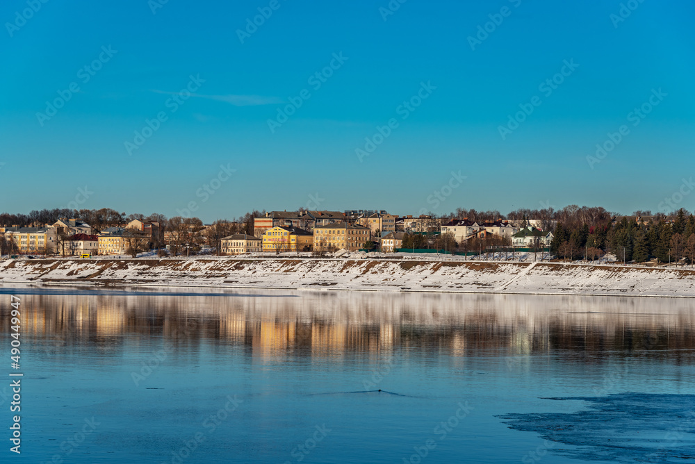 Panoramic view of a small provincial town on the banks of the river at sunset	