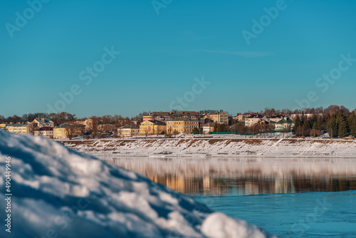 Panoramic view of a small provincial town on the banks of the river at sunset 