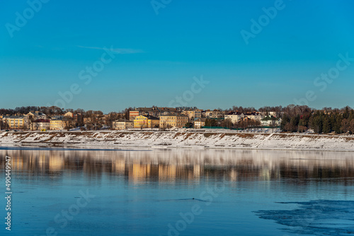 Fototapeta Naklejka Na Ścianę i Meble -  Panoramic view of a small provincial town on the banks of the river at sunset	