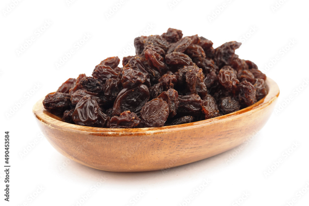 Organic dried Raisins in wooden bowls on white background, Currant Organic dried Raisins in wooden bowls on white background, Currant
