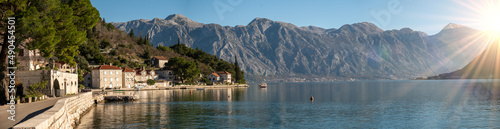 Perast, Montenegro and bay of Kotor. Scenic panorama view of historic town Perast at famous Bay of Kotor with blooming flowers on beautiful sunny day with blue sky in summer, panorama