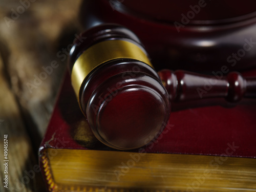 close-up of judge gavel and law books in court, concept of law and justice