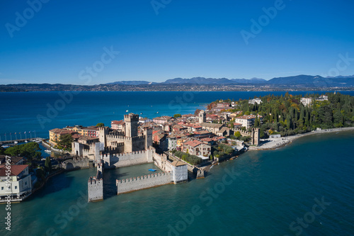 Aerial panorama of Sirmione. Autumn in Sirmione. Sirmione aerial view. Top view, historic center of the Sirmione peninsula, lake garda. Lake Garda, Sirmione, Italy. Italian castle on Lake Garda. © Berg