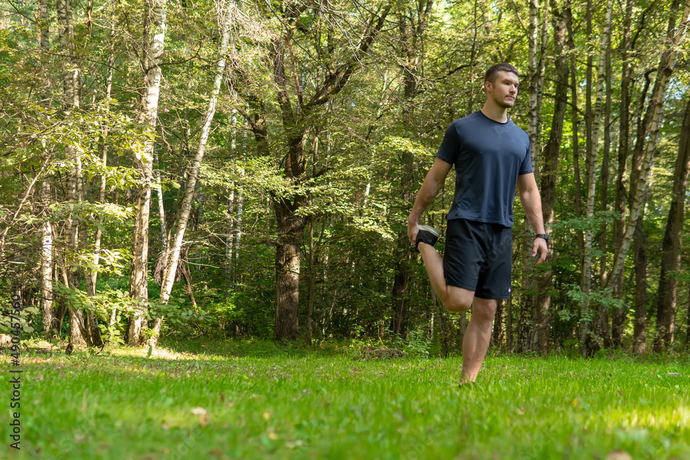 A man athlete runs in the park outdoors, around the forest, oak trees green grass young enduring athletic athlete healthy runner nature, fitness outdoor endurance recreation woods wellbeing. body A man athlete runs in the park outdoors, around the forest, oak trees green grass young enduring athletic athlete healthy runner nature, fitness outdoor endurance recreation woods wellbeing. body