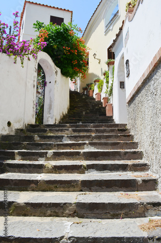 Positano steep steps, narrow pedestrian street among white buildings, Amalfi Coast, Italy