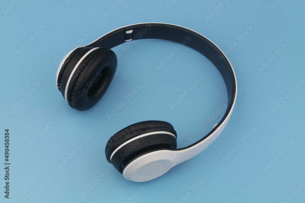 Wireless headphones on blue background Wireless headphones on blue background