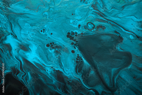 Fluid Art. Blue abstract wave swirls on black background. Marble effect background or texture © colnihko