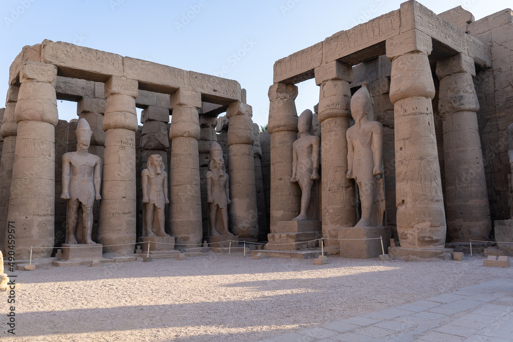 Columns and statues in the courtyard of Ramses II of the Luxor Temple