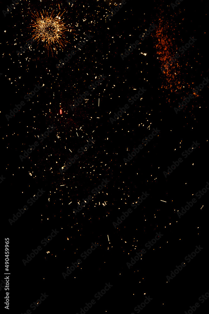 blurry sparks from fireworks on black background