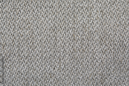 Knitted texture. Texture of jacquard fabric with gray geometric pattern. Crochet mosaic pattern.