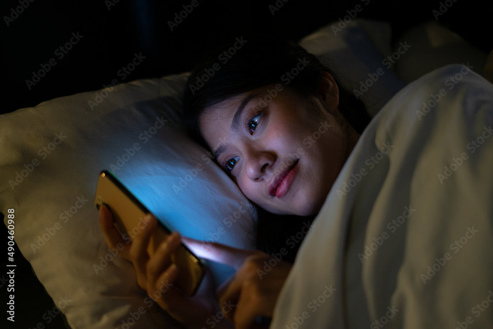 Young Asian woman using smartphone at midnight Young Asian woman using smartphone at midnight