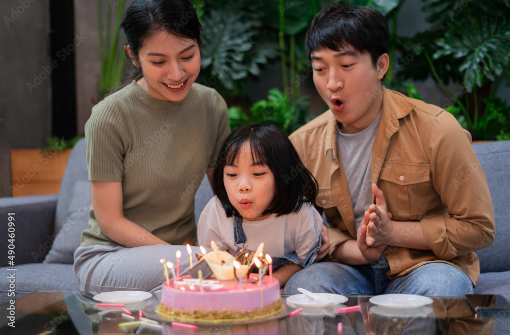 Young Asian couple celebrates their daughter's birthday Young Asian couple celebrates their daughter's birthday