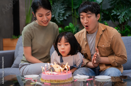 Young Asian couple celebrates their daughter's birthday