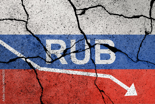 Ruble falls to historic lows. Flag of Russia painted on a concrete wall with ruble sign photo