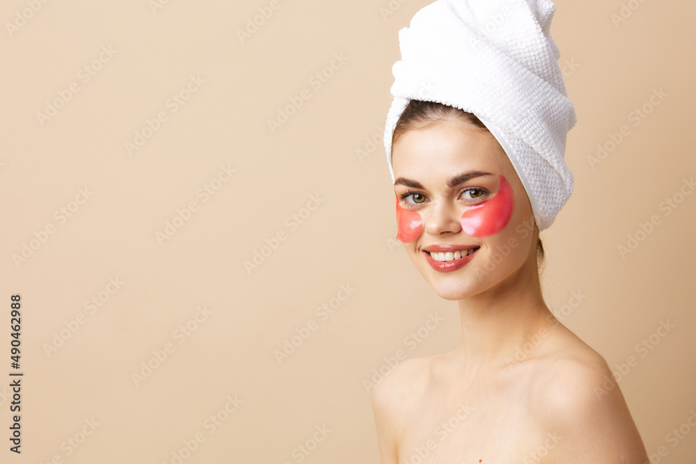 beautiful woman with a towel on his head gesturing with his hands skin care beige background beautiful woman with a towel on his head gesturing with his hands skin care beige background