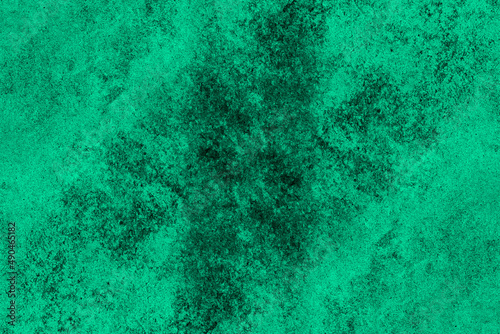 Green painted old concrete wall with dark grunge texture for background