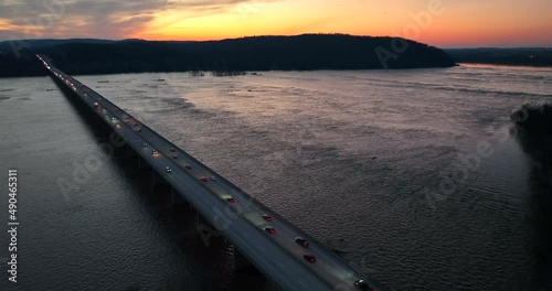 Cars with headlights on drive across Route 30 bridge over Susquehanna River. Lancaster to York County Pennsylvania. Sunset view. Aerial. photo