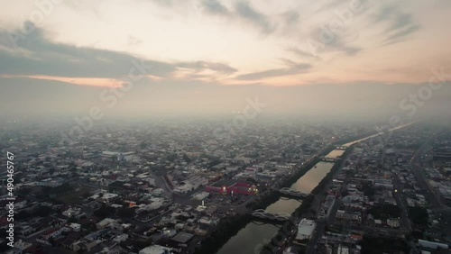 Aerial - Dusk over the river in Reynosa, Tamaulipas, Mexico, truck left photo