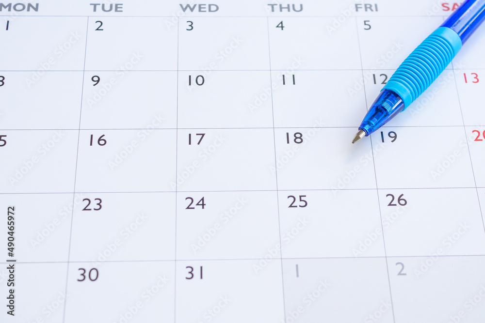 Blue pen on calendar page background business planning appointment meeting concept Blue pen on calendar page background business planning appointment meeting concept