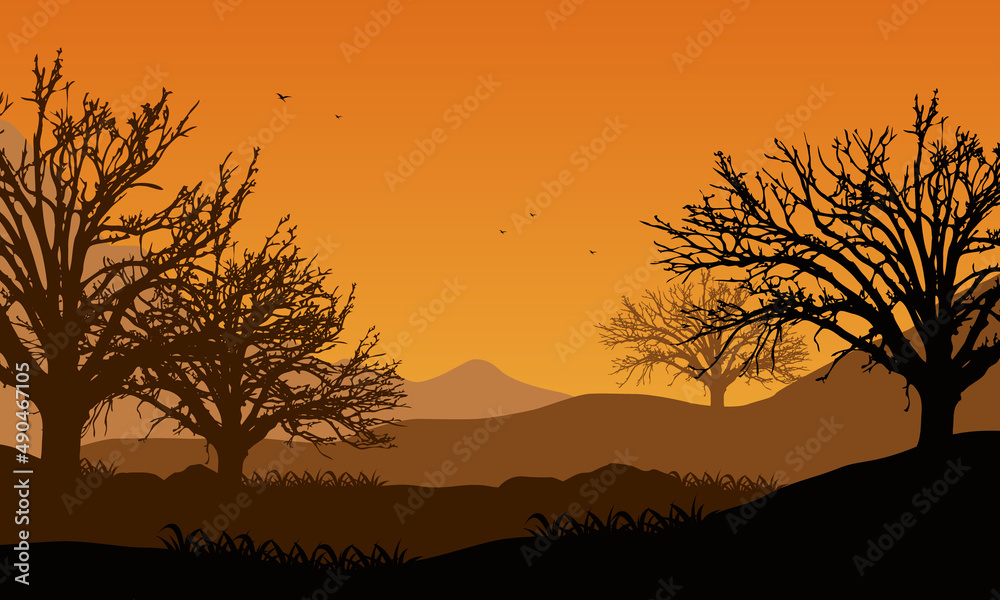 Extraordinary Panorama of the mountains at sunrise from the countryside with the silhouettes of dry pine trees around