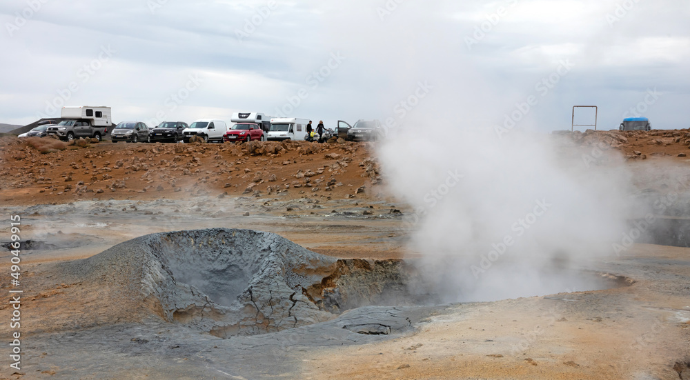 Hverir, Iceland on august 1, 2021: Parking near a steaming fumarole in geothermal area of Hverir, Iceland