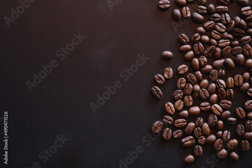 close up of roasted coffee beans on black background with copy space
