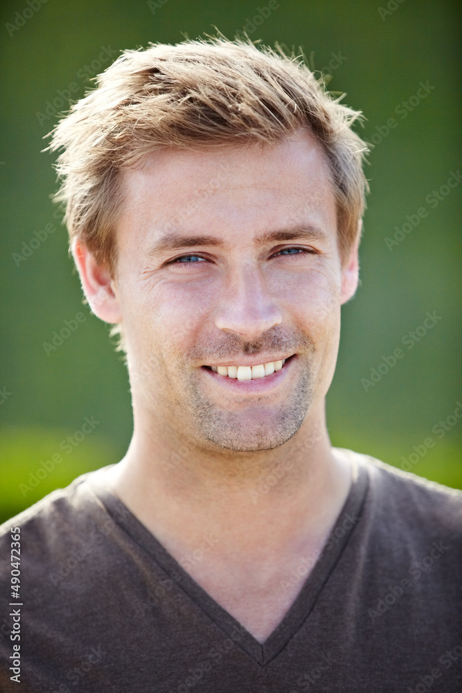 Casual charm. A handsome young man smiling broadly at the camera. Casual charm. A handsome young man smiling broadly at the camera.