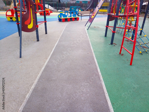 Colorful playground background. Grey-blue rubber outdoor playground © Sofya