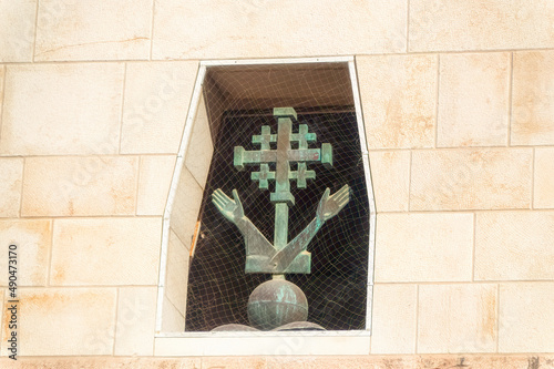 Jerusalem Cross with two hands at The Church of the Annunciation in Nazareth, Israel. photo