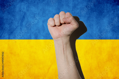 Fist on Ukraine flag, stop war, crisis protest, multi purpose concept 