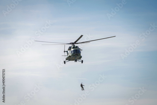 Rescue of the person by means of the helicopter. Rescue operation during the war. War in Ukraine. Space for text.
