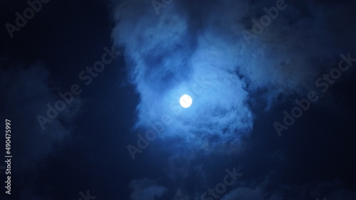 The moon night view with the bright moon in the dark sky at night © Bo