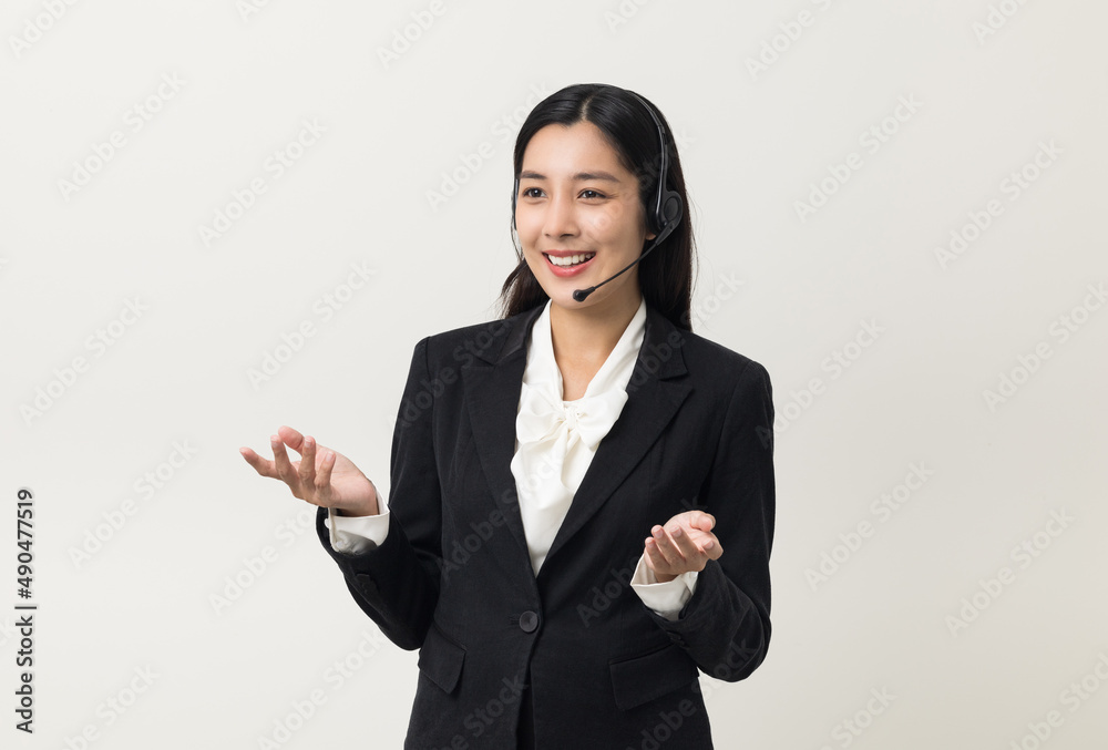 Happy young asian business woman call centre. Welcome female operator put on smalltalk headphone standing on isolated white background. Happy young asian business woman call centre. Welcome female operator put on smalltalk headphone standing on isolated white background.
