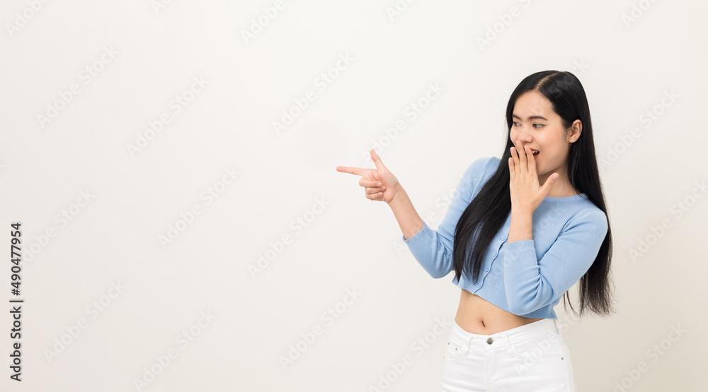 Beautiful asian woman pointing finger into blank space. Smiling female standing pose on isolated white background. Attractive Teenager girl around 25 looking at empty space for advertise text. Beautiful asian woman pointing finger into blank space. Smiling female standing pose on isolated white background. Attractive Teenager girl around 25 looking at empty space for advertise text.