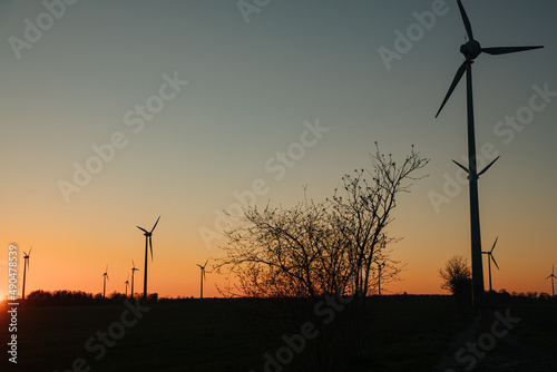 wind turbine in the field. wind turbine on sky. Large wind turbine. Silhouettes of pinwheels in the evening 