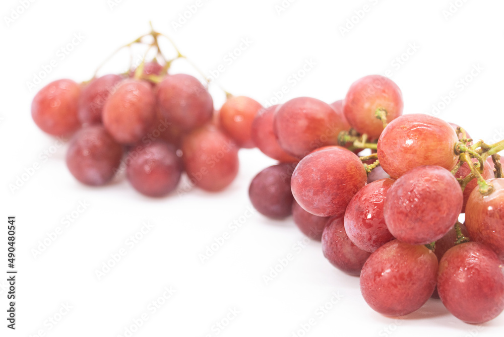 Red fresh red grapes display on white background