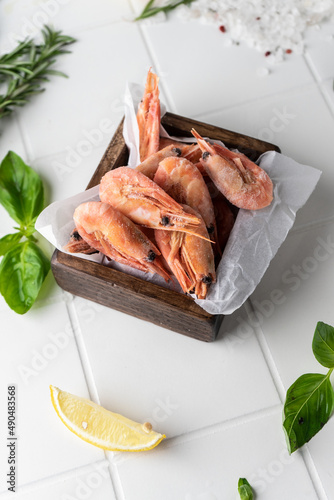 Thawed peeled shrimp, seafood, delicacy. on a white background, in a dish. beautiful product presentation