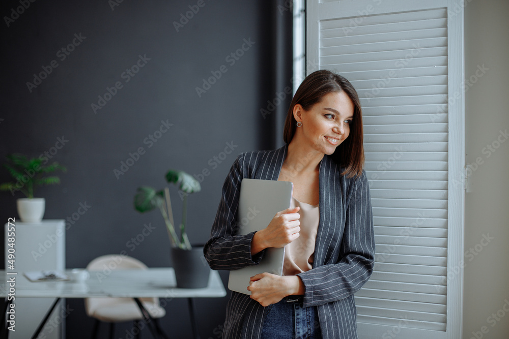 Young woman working on laptop in modern office Young woman working on laptop in modern office
