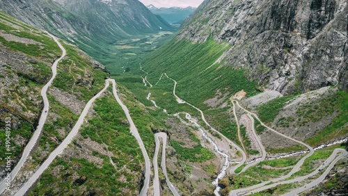 Trollstigen, Andalsnes, Norway. Cars Goes On Serpentine Mountain Road Trollstigen. Famous Norwegian Landmark And Popular Destination. Norwegian County Road 63 In Summer Day. 4K. photo