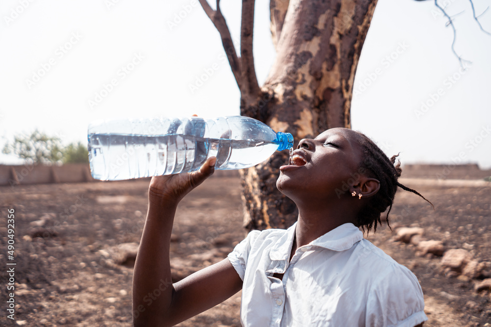 african woman drinking water