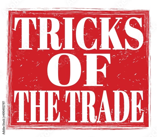 TRICKS OF THE TRADE, text on red stamp sign photo