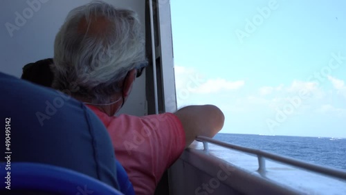 A man thinking about life on the boat to Ischia island, Naples, Italy photo